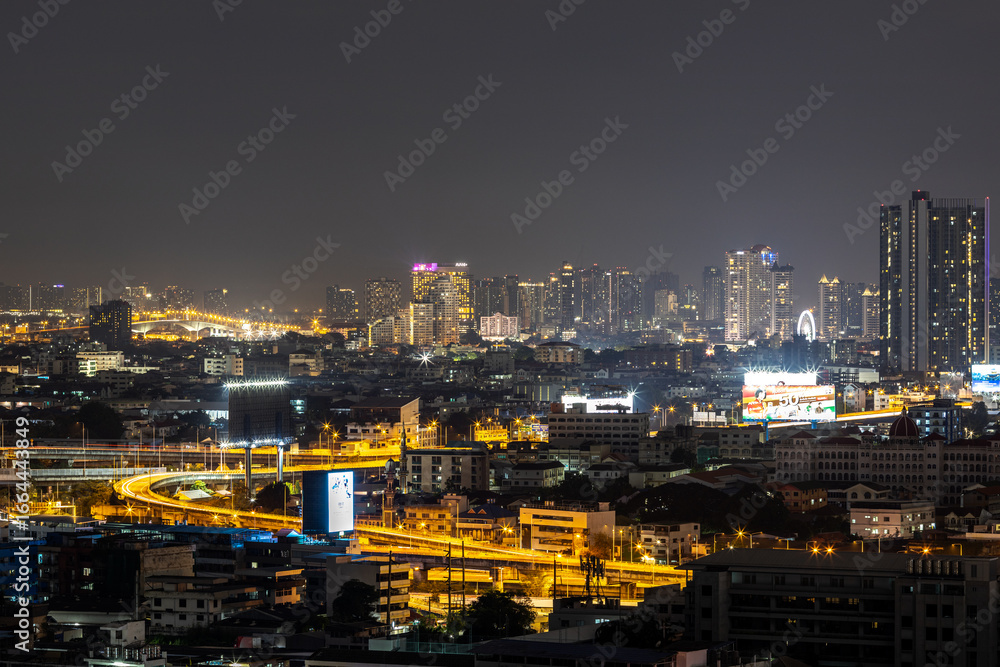 Fototapeta premium Blurred background of night lights in Bangkok. Fireworks, traffic lights, lights on bridges over the river, the spread of electric lighting technology in homes.