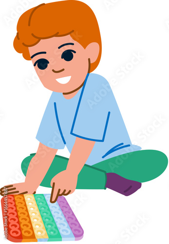 Smiling child playing with pop it toy, pressing colorful bubbles