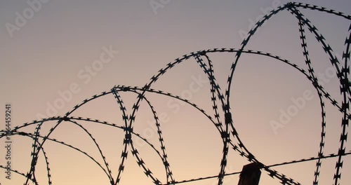 Background tracking shot of the cloudless sky over barbed wire for use in a composition for titles or titles, empty space for text or inscription.