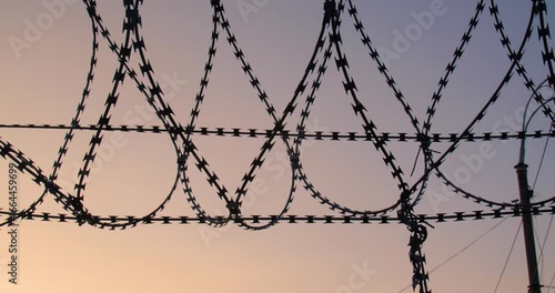 Background tracking shot of the cloudless sky over barbed wire for use in a composition for titles or titles, empty space for text or inscription.