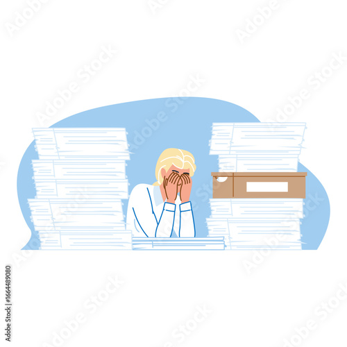 Stressed office worker hiding face behind hands at desk with piles of paperwork