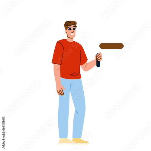 Painter holding paint roller smiling and painting wall
