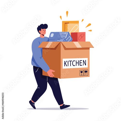 A young man in a blue sweater carefully carrying a large overflowing cardboard moving box labeled Kitchen.