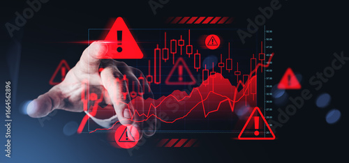 Fotografie Hand interacting with digital chart showing financial crisis warning symbols and negative trend lines on dark background, representing risk management concept