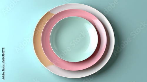 Stacked Colorful Ceramic Plates in Pastel Colors on a Soft Teal Background