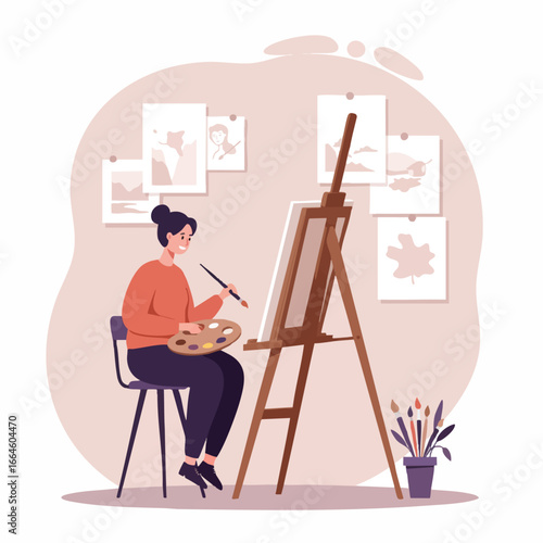 Young woman artist painting on a canvas with an easel in her creative studio. Hobby and creative profession concept