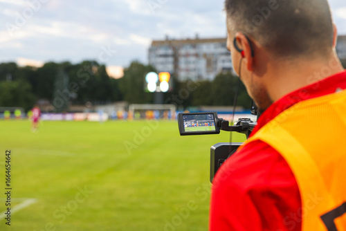 Football Cameraman Filming Match with Screen Display – Sports Action and Media Concept