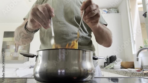 Wallpaper Mural Close up faceless man preparing and cooking lunch or dinner in kitchen, cutting ingredients and stirring food, everyday lifestyle detail, homemade meal, domestic activity and authentic culinary routin Torontodigital.ca