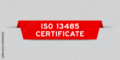 Red color inserted label with word ISO 13485 certificate on gray background