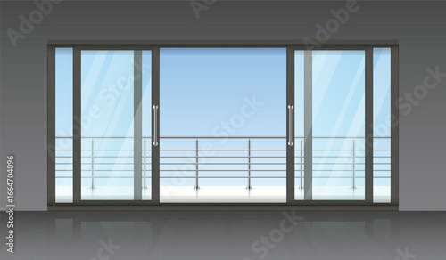 A set of sliding glass doors opens to a balcony, offering an unobstructed view of the clear sky. Sunlight streams through the glass, illuminating the gray tiled floor.
