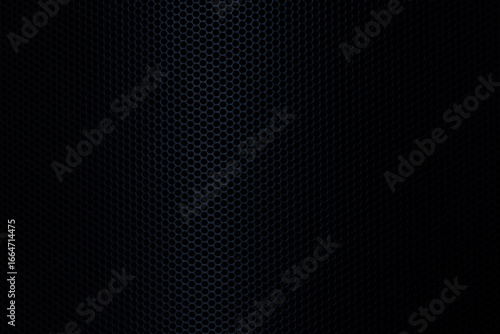 Black macro technology background,Speaker grille texture,Grunge close-up photo of wall panels with stair-step structure in darkness. Abstract textured background.