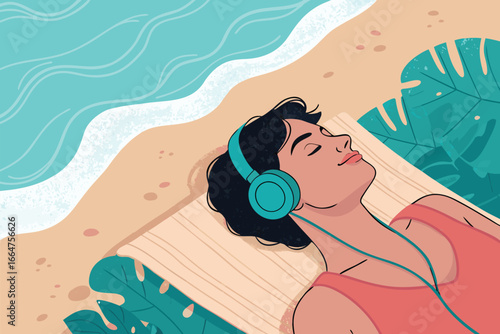 Person with headphones on a towel, listening to music.