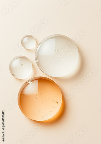 Elegant arrangement of liquid droplets showcasing texture and color on a soft background.