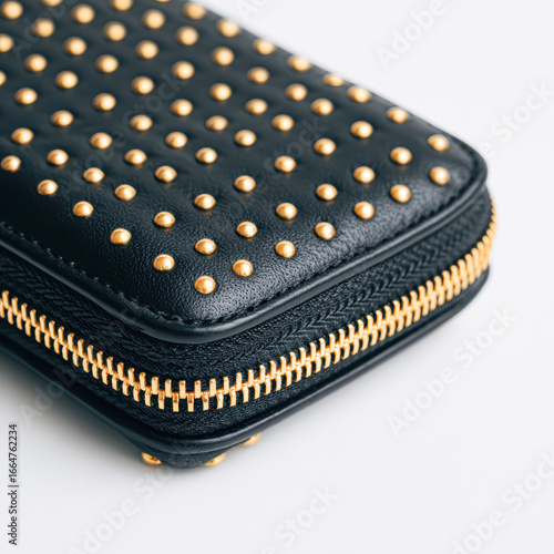 Wallpaper Mural A stylish black wallet adorned with gold studs and a sleek zipper, perfect for securing essentials with a touch of elegance. Torontodigital.ca