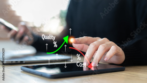 Business concept with a hand using a tablet showing cost reduction and quality improvement graph, technology for efficiency, finance and digital strategy.