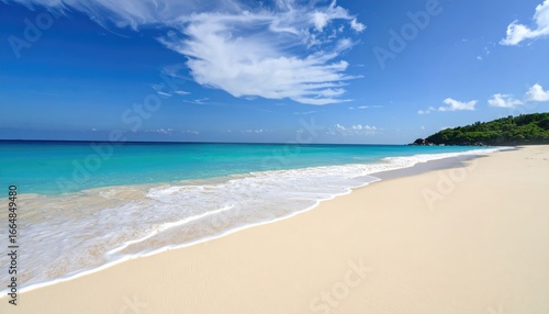 A serene beach with white sand and clear turquoise waters under blue skies