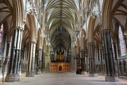 Lincoln, Lincolnshire, England – August 21 2025: Interior view of Gothic architecture at Lincoln Cathedral showcasing intricate vaulted ceilings and vibrant stained glass windows.