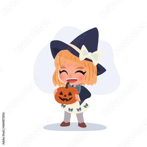 a cute little girl dressed as a witch holding a carved pumpkin jack o lantern smiling happily during halloween celebration