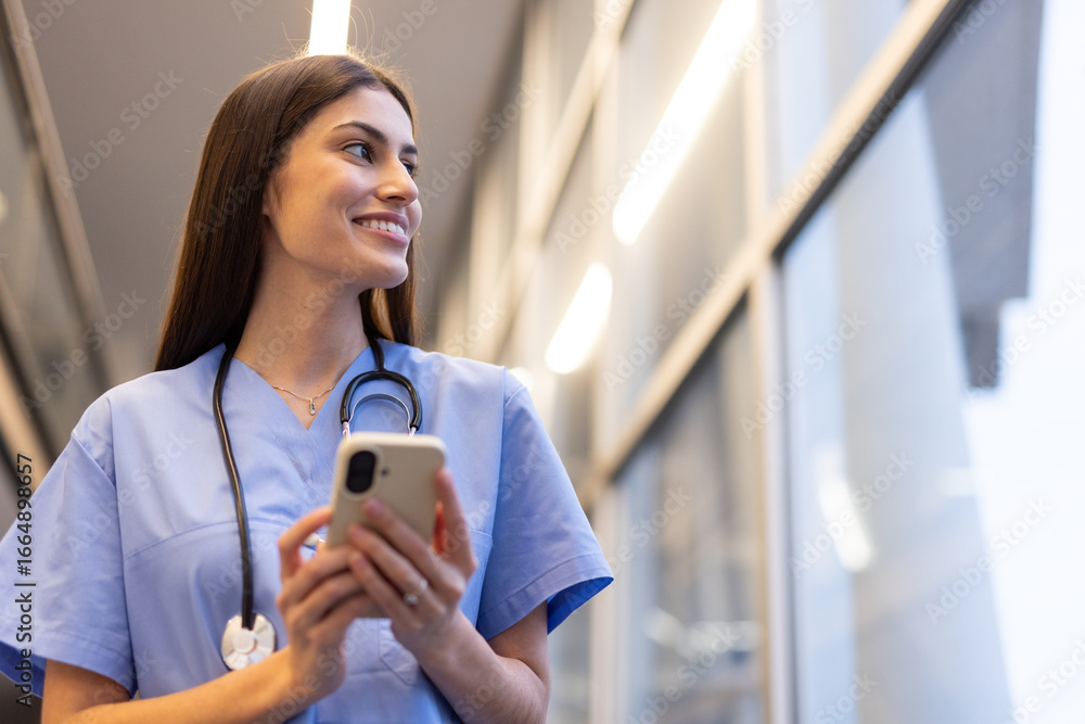 Fototapeta premium Confident medical professional using mobile phone technology in modern healthcare setting, showcasing efficiency and connectivity