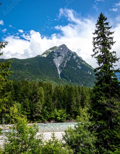 Mountain peak above a river and forest