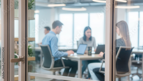 Modern Office Collaboration Space with Diverse Professionals Engaged in Team Work and Discussion