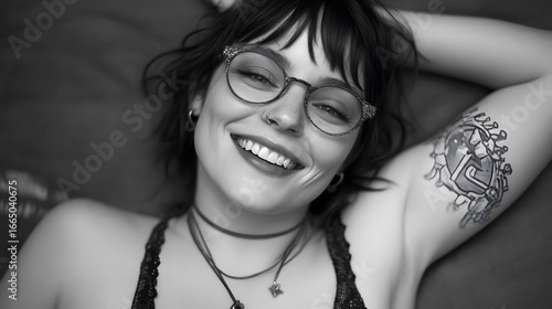 Smiling Woman with Glasses, Tattoo, and Necklaces Black and White Portrait Photography