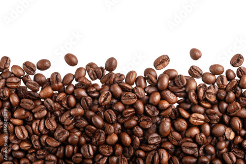 Close-up of many coffee beans, dark brown, slightly unevenly distributed, with some visible edges highlighted
