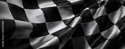 The Checkered Flag Waving Over Glossy Fabric With Dramatic Light And Motion