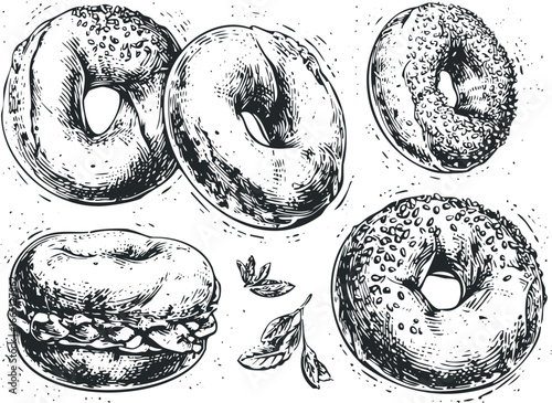 Assortment of seeded and plain bagels with a sandwich and mint leaves