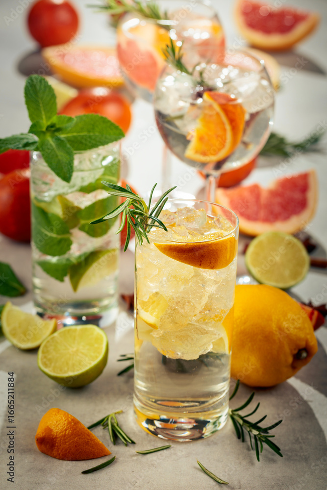 Fototapeta premium Refreshing summer cocktails with citrus on a white marble table.