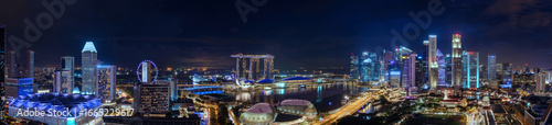 Illuminated Singapore cityscape with glowing harbor and crystal skyscrapers