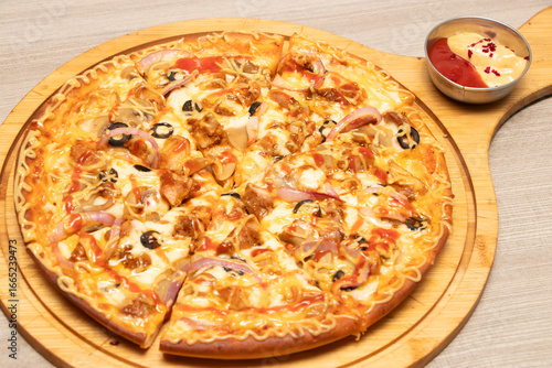 Wallpaper Mural Hot Pizza Topped with Chicken, Onion, Olives, and Cheese on cutting board side view of bangladeshi food Torontodigital.ca