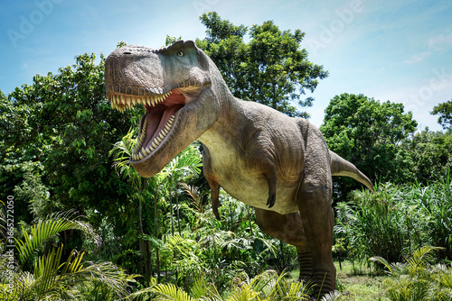 Pattaya​ Dinosaur Kingdom- 8th June 2025: A large dinosaur statue,life-size Tyrannosaurus Rex (T-Rex) model at Chonburi Province,Thailand.