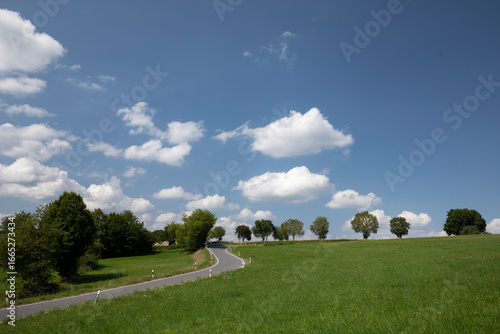 road in the countryside with clouds and blue sky