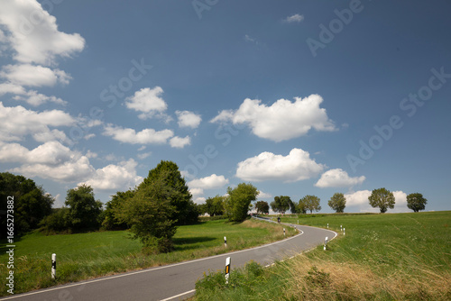 road in the countryside with clouds and big sky