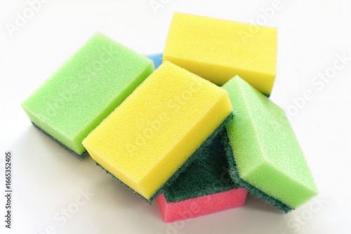 Colourful scrub sponges on the table. Cleaning washing concept. Household tools.