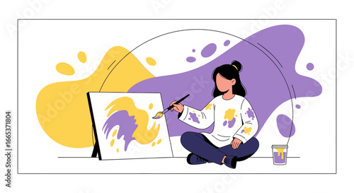 Creative expression: A young woman immersed in painting a colorful abstract piece