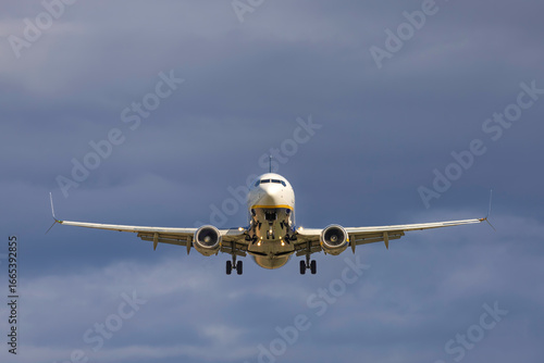 Front view of a Ryanair airplane landing on the runway