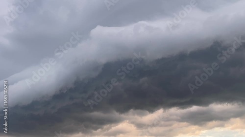 Rolling thunderstorm clouds in dramatic sky at dusk