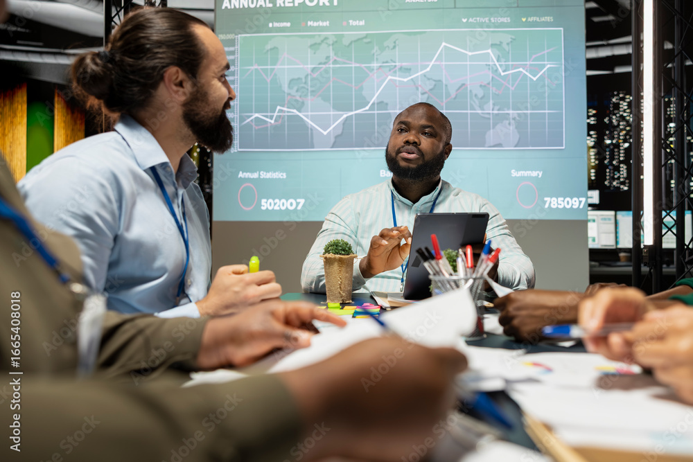 © DC Studio - Team of general managers attending a briefing meeting late at night to verify updates on regulatory changes or industry standards. Business professionals reviewing all data analysis.