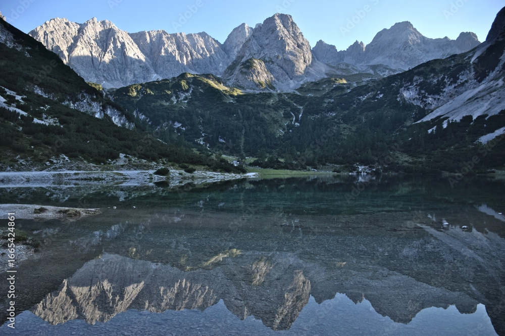 Fototapeta premium Picturesque view of the Mieming Range in Austria. Sunny day, alpine peaks, and serene mountain landscape.