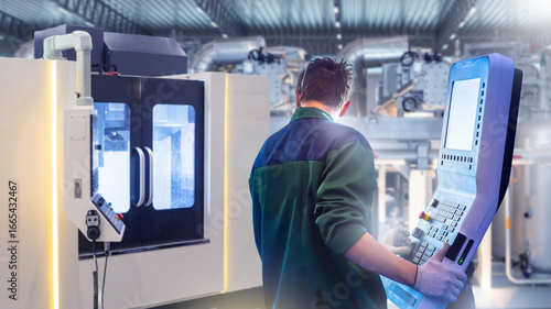 Tableau sur toile Engineer operates CNC machine with digital control panel in modern factory, concept of automation, precision engineering, manufacturing, industry 4
