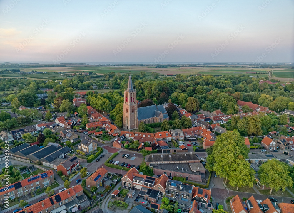 Obraz premium Typical Dutch church Geerteskerk in small town Kloetinge aerial view