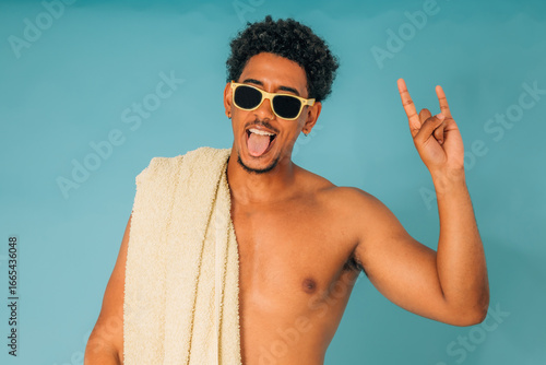 Photography young man with sunglasses in swimming trunks in summer isolated on background