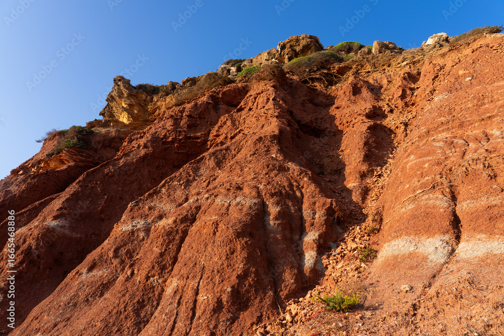 Fototapeta premium Telheiro beach at sunset in Sagres, Portugal, with its colorful cliffs.