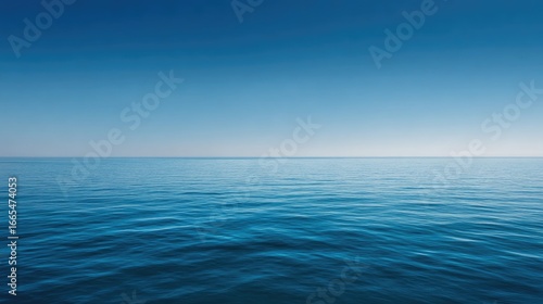 Calm Blue Ocean Surface Under Clear Sky with Gentle Waves and Smooth Horizon at Sunrise or Sunset