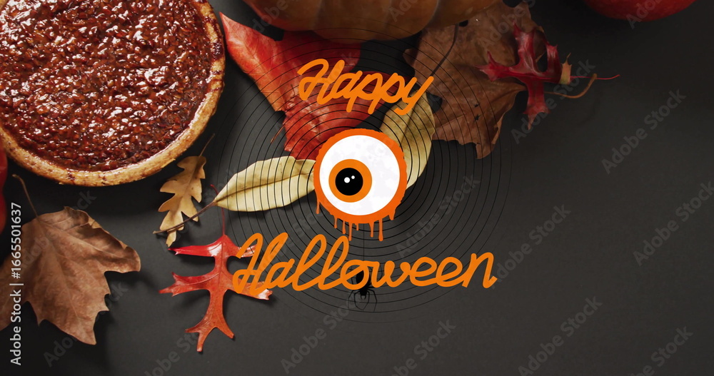 Fototapeta premium Happy Halloween text with eyeball image over autumn leaves and pumpkin pie