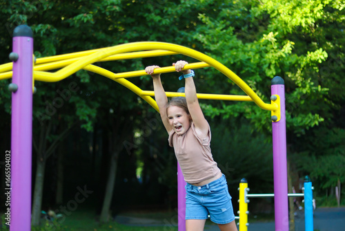 Girl playing on colorful playground equipment