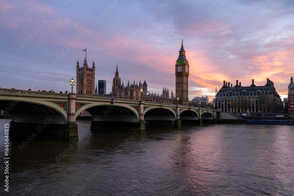Westminster at Dawn: Iconic London landmarks, the Palace of Westminster and Big Ben, are beautifully silhouetted against the soft hues of dawn, reflecting on the calm water of the river Thames. Westminster at Dawn: Iconic London landmarks, the Palace of Westminster and Big Ben, are beautifully silhouetted against the soft hues of dawn, reflecting on the calm water of the river Thames.