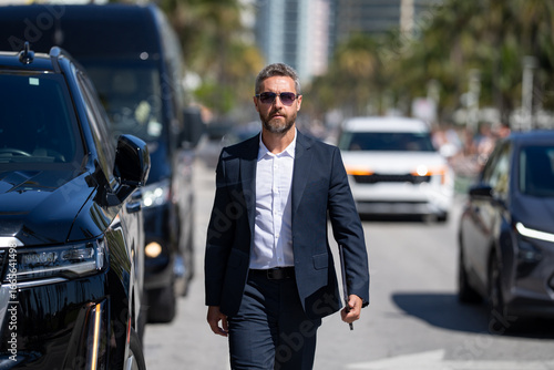 Wallpaper Mural Success business man near expensive luxury car. Success businessman. Mature success business man in suit. Rich businessman in suit walking outdoor. Luxury successful business man. Business success. Torontodigital.ca